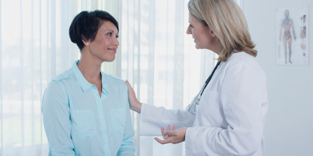 A doctor meeting with a patient about heavy menstrual bleeding and endometrial ablation