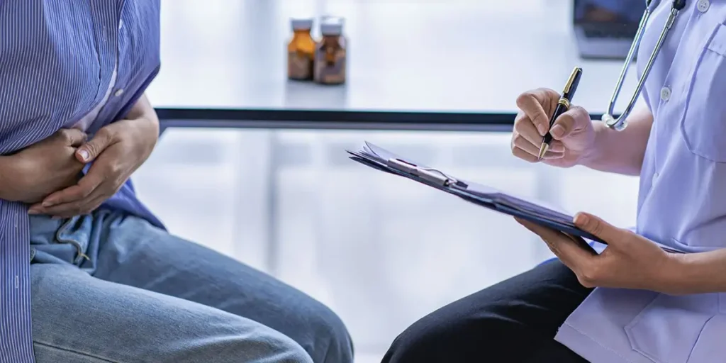 A doctor and patient converse, focusing on health issues in a professional healthcare setting.